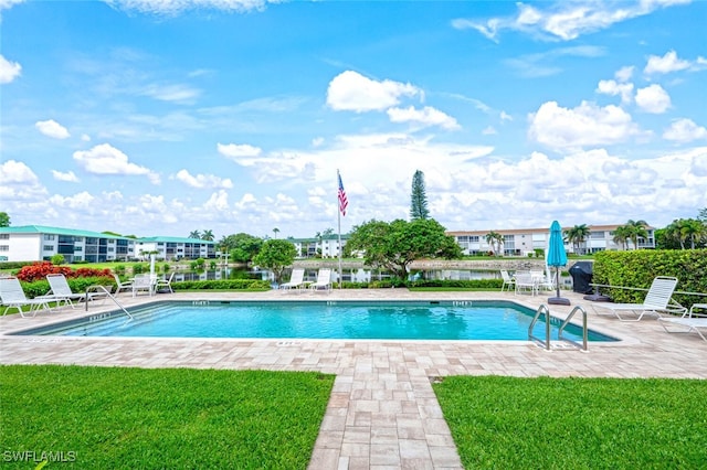 3055 Riviera Dr Unit 306, Naples, FL 34103 - community pool with a patio area and a lawn