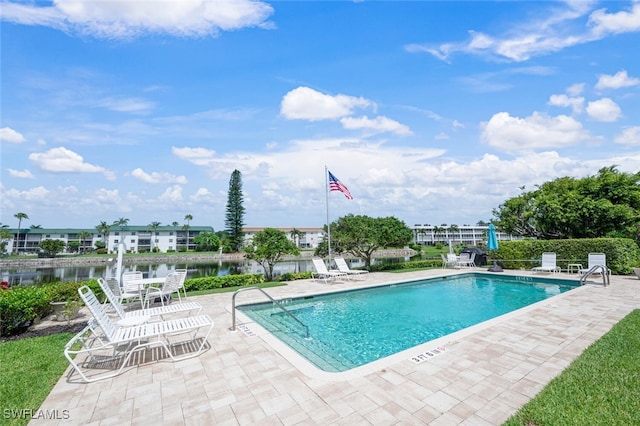 3055 Riviera Dr Unit 306, Naples, FL 34103 - community pool featuring a patio and a water view