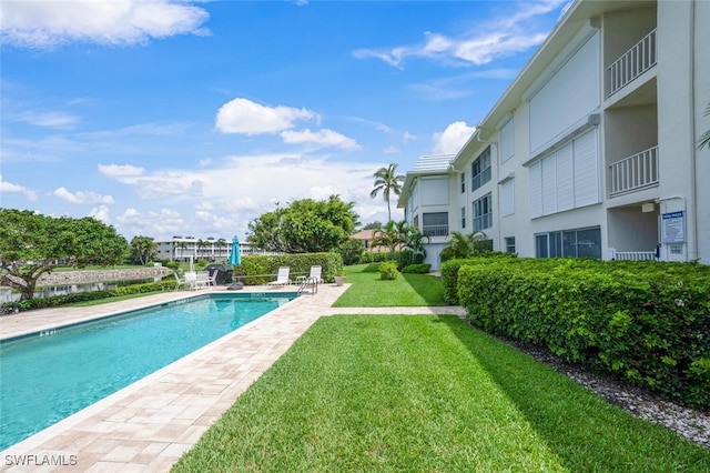 3055 Riviera Dr Unit 306, Naples, FL 34103 - swimming pool featuring a yard and a patio area