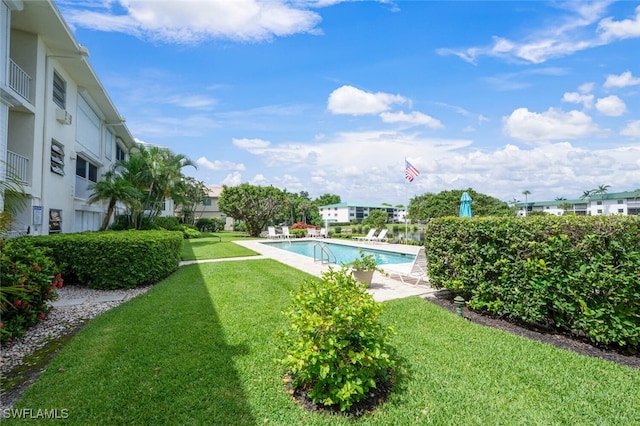 3055 Riviera Dr Unit 306, Naples, FL 34103 - community pool featuring a lawn and a patio