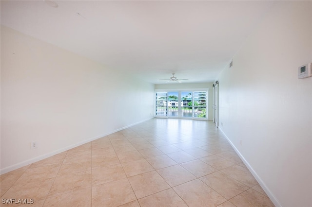 3055 Riviera Dr Unit 306, Naples, FL 34103 - empty room with light tile patterned floors, baseboards, and ceiling fan