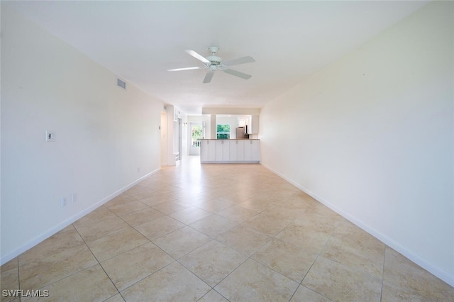 3055 Riviera Dr Unit 306, Naples, FL 34103 - unfurnished living room featuring a ceiling fan, baseboards, and light tile patterned flooring