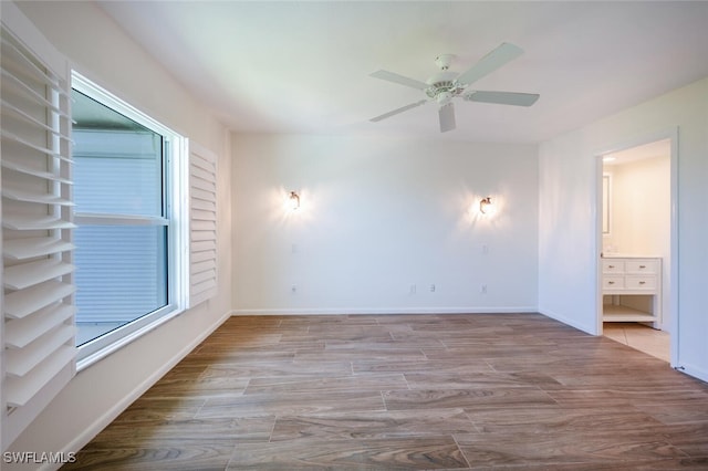 3055 Riviera Dr Unit 306, Naples, FL 34103 - unfurnished room with ceiling fan, wood finished floors, and baseboards