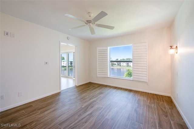 3055 Riviera Dr Unit 306, Naples, FL 34103 - unfurnished room with healthy amount of natural light, wood finished floors, baseboards, and a ceiling fan