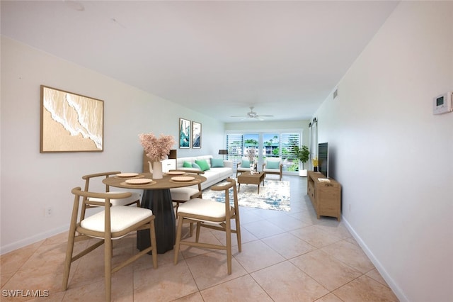 3055 Riviera Dr Unit 306, Naples, FL 34103 - dining area featuring light tile patterned flooring, baseboards, and ceiling fan
