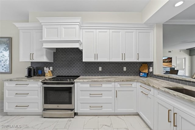1940 Willow Bend Cir Unit 102, Naples, FL 34109 - kitchen featuring stainless steel electric range oven, light marble finish flooring, white cabinetry, light stone countertops, and backsplash