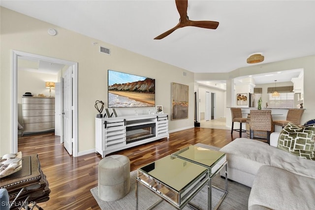 1940 Willow Bend Cir Unit 102, Naples, FL 34109 - living area featuring wood finished floors, ceiling fan, and a fireplace