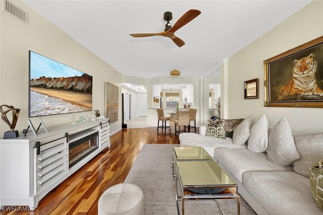 1940 Willow Bend Cir Unit 102, Naples, FL 34109 - living area with ceiling fan, wood finished floors, and a fireplace