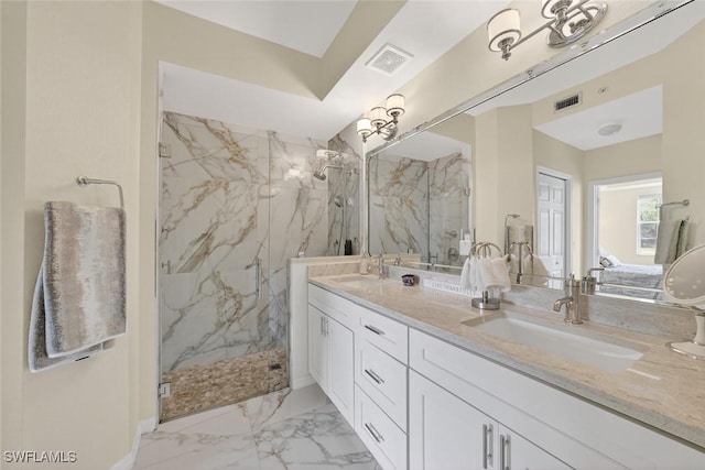 1940 Willow Bend Cir Unit 102, Naples, FL 34109 - ensuite bathroom with a marble finish shower, double vanity, and marble finish floors