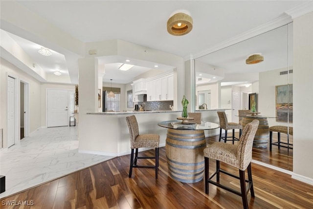 1940 Willow Bend Cir Unit 102, Naples, FL 34109 - dining space featuring baseboards and wood finished floors