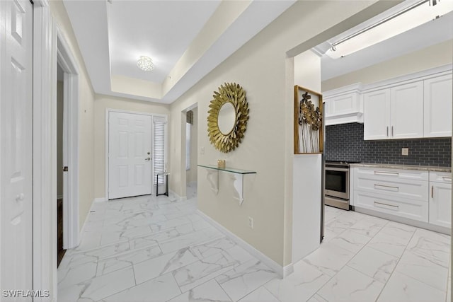 1940 Willow Bend Cir Unit 102, Naples, FL 34109 - kitchen with stainless steel range oven, light marble finish floors, and white cabinetry