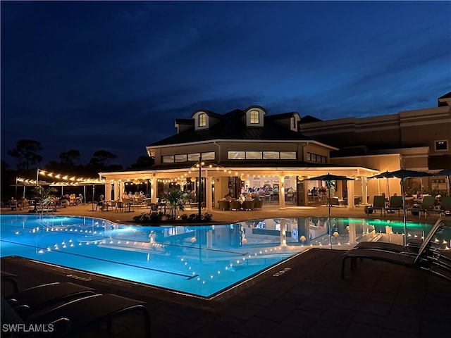 1940 Willow Bend Cir Unit 102, Naples, FL 34109 - pool at twilight with a patio and a community pool
