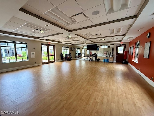 1940 Willow Bend Cir Unit 102, Naples, FL 34109 - workout room featuring wood finished floors, plenty of natural light, and a ceiling fan