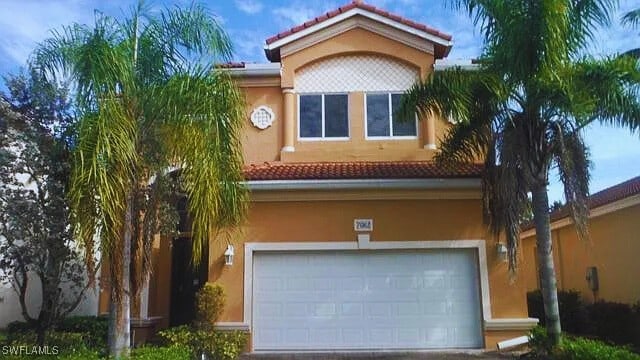 7082 Aliso Ave, West Palm Beach, FL 33413 - view of front of house featuring a tile roof, stucco siding, a garage, and driveway