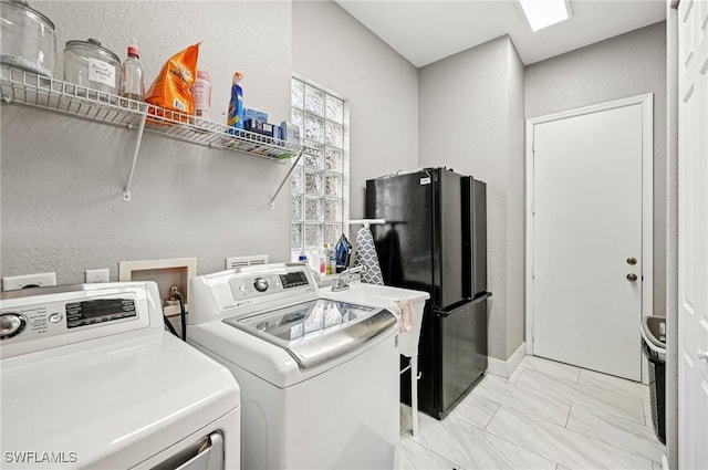 7082 Aliso Ave, West Palm Beach, FL 33413 - washroom with washing machine and dryer, light marble finish flooring, and a textured wall