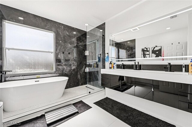 7082 Aliso Ave, West Palm Beach, FL 33413 - bathroom with a marble finish shower, double vanity, and a freestanding tub
