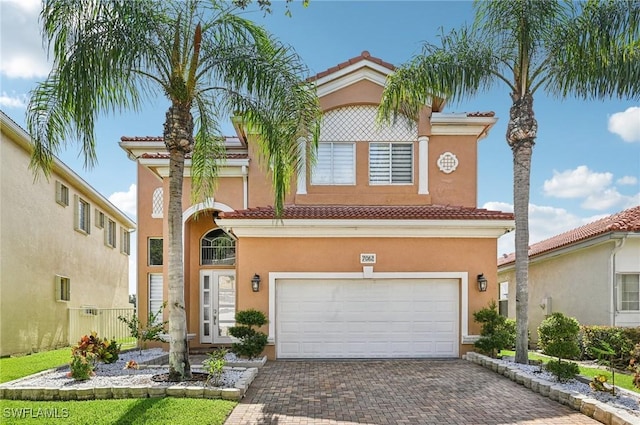 7082 Aliso Ave, West Palm Beach, FL 33413 - view of front of home featuring a tile roof, an attached garage, stucco siding, and decorative driveway