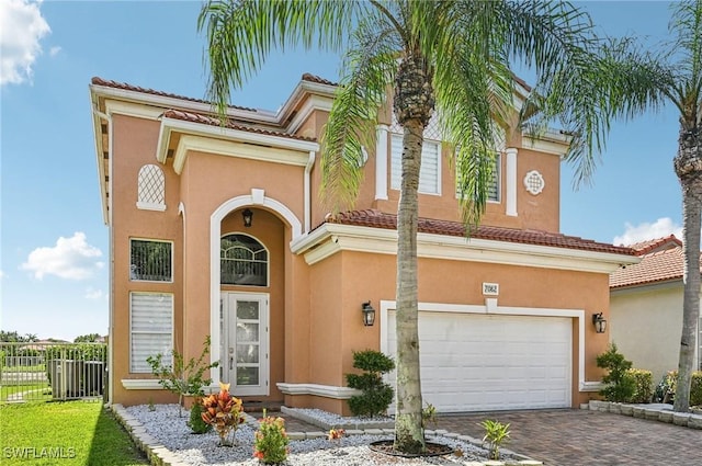 7082 Aliso Ave, West Palm Beach, FL 33413 - mediterranean / spanish-style house with a garage, stucco siding, and decorative driveway