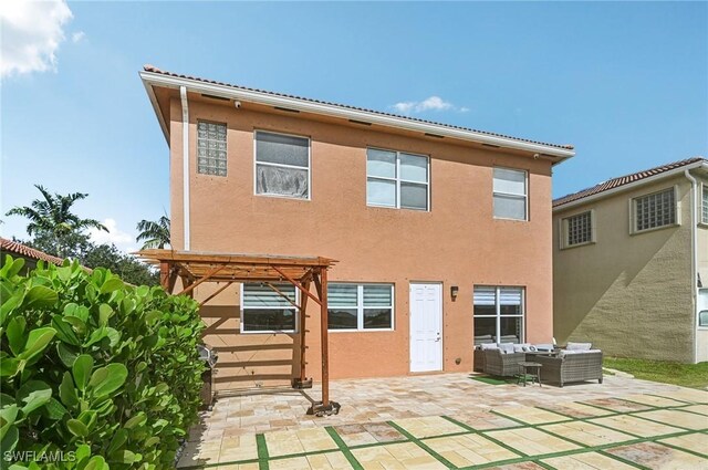7082 Aliso Ave, West Palm Beach, FL 33413 - rear view of property featuring outdoor lounge area, a patio, stucco siding, and a pergola