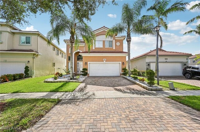 7082 Aliso Ave, West Palm Beach, FL 33413 - view of front facade featuring decorative driveway, stucco siding, a front lawn, a tiled roof, and an attached garage