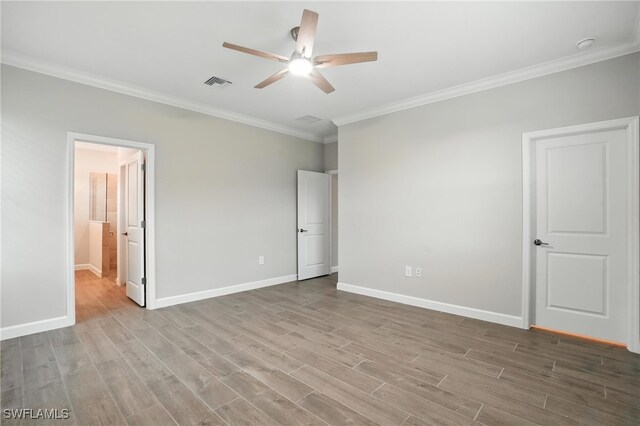 19270 Hinkley Dr, Estero, FL 33928 - unfurnished bedroom with ornamental molding, wood finished floors, ensuite bathroom, and ceiling fan
