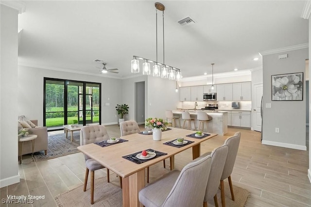 19270 Hinkley Dr, Estero, FL 33928 - dining area with crown molding, light wood-type flooring, a ceiling fan, and recessed lighting