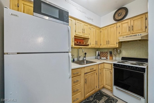 235 Seaview Ct Unit B2, Marco Island, FL 34145 - kitchen with white appliances, under cabinet range hood, a sink, tasteful backsplash, and light countertops