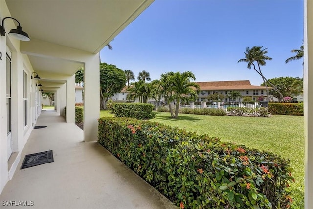 235 Seaview Ct Unit B2, Marco Island, FL 34145 - covered porch featuring a yard