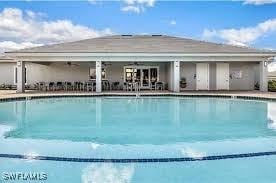 1050 Enbrook Loop, Naples, FL 34114 - community pool with a patio area