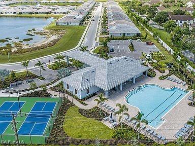 1050 Enbrook Loop, Naples, FL 34114 - drone / aerial view of a large body of water and a pool area