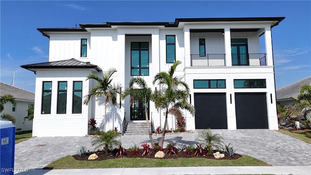 771 Orchid Ct, Marco Island, FL 34145 - view of front of home with a balcony, decorative driveway, a standing seam roof, an attached garage, and metal roof