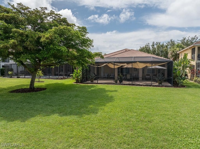 12455 Muddy Creek Ln, Fort Myers, FL 33913 - view of green lawn with a patio and glass enclosure