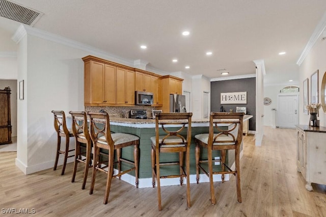 12455 Muddy Creek Ln, Fort Myers, FL 33913 - kitchen with appliances with stainless steel finishes, ornamental molding, light wood-style flooring, baseboards, and a peninsula