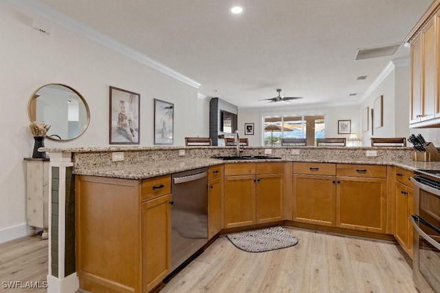 12455 Muddy Creek Ln, Fort Myers, FL 33913 - kitchen featuring stainless steel appliances, a sink, light wood-style flooring, crown molding, and light stone countertops