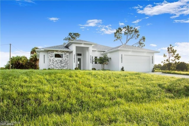 837 Grant Blvd, Lehigh Acres, FL 33974 - prairie-style house featuring a garage and stucco siding