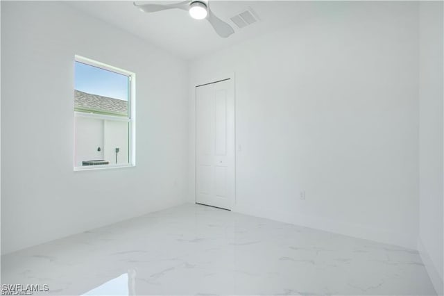 837 Grant Blvd, Lehigh Acres, FL 33974 - unfurnished room featuring marble finish flooring and a ceiling fan