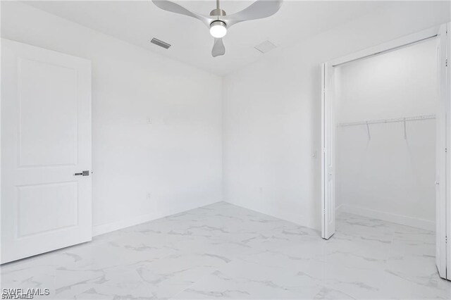 837 Grant Blvd, Lehigh Acres, FL 33974 - unfurnished bedroom featuring marble finish floors, a closet, a ceiling fan, and baseboards