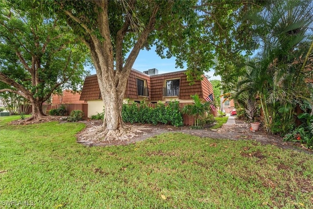 5249 Cedarbend Dr Unit 2, Fort Myers, FL 33919 - view of front of property featuring mansard roof and a front lawn