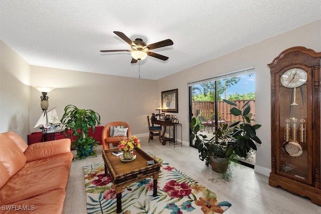 5249 Cedarbend Dr Unit 2, Fort Myers, FL 33919 - living area with a ceiling fan, baseboards, and a textured ceiling