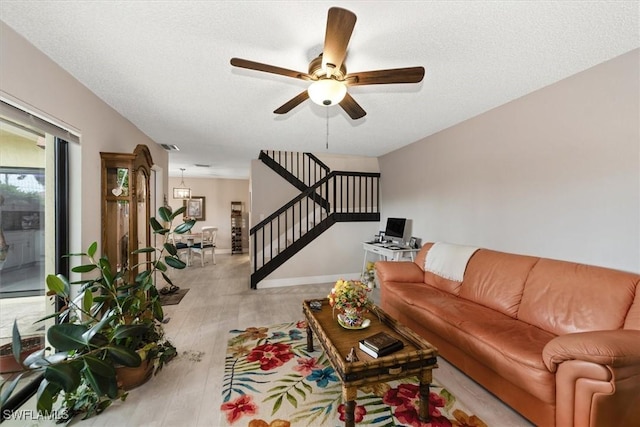 5249 Cedarbend Dr Unit 2, Fort Myers, FL 33919 - living area with stairs, light wood-style floors, and ceiling fan