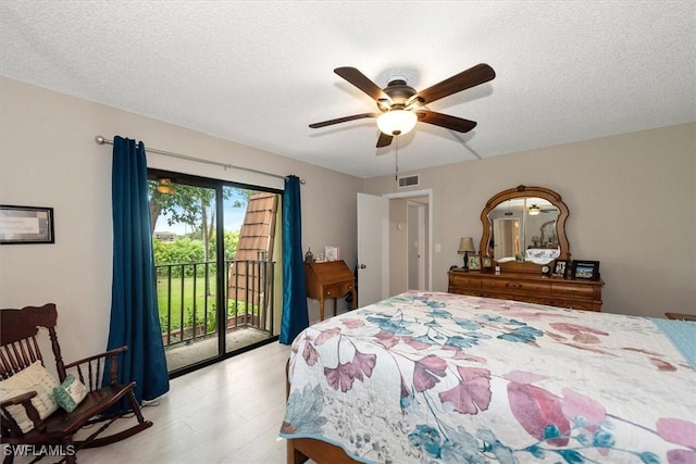 5249 Cedarbend Dr Unit 2, Fort Myers, FL 33919 - bedroom featuring access to exterior, light wood-style flooring, a ceiling fan, and a textured ceiling