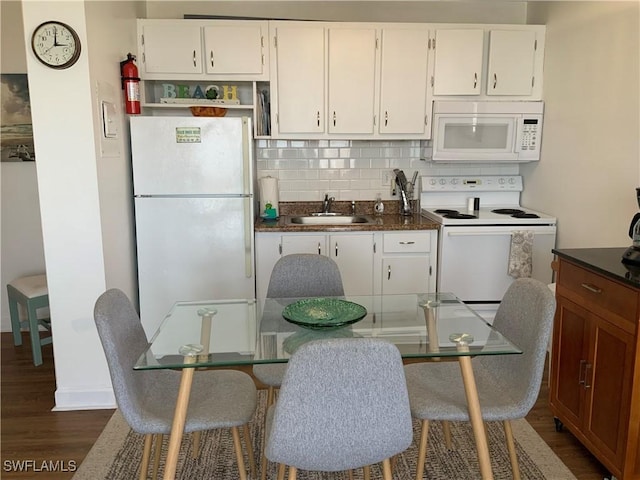 7360 Estero Blvd Unit 1102, Fort Myers Beach, FL 33931 - kitchen with white appliances, a sink, dark wood-style flooring, decorative backsplash, and white cabinetry
