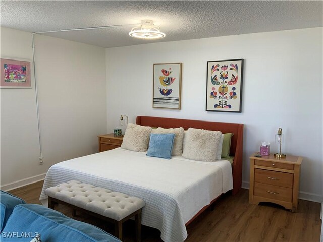 7360 Estero Blvd Unit 1102, Fort Myers Beach, FL 33931 - bedroom featuring wood finished floors and a textured ceiling