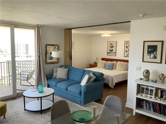 7360 Estero Blvd Unit 1102, Fort Myers Beach, FL 33931 - bedroom featuring access to exterior, wood finished floors, and a textured ceiling