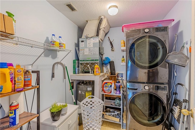 164 Belina Dr E Unit 4, Naples, FL 34104 - washroom with estacked washer and dryer and a textured ceiling