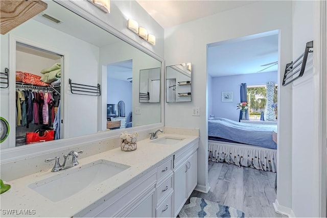 164 Belina Dr E Unit 4, Naples, FL 34104 - ensuite bathroom with double vanity, wood finished floors, and a spacious closet