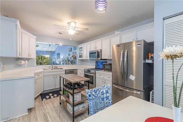 164 Belina Dr E Unit 4, Naples, FL 34104 - kitchen featuring appliances with stainless steel finishes, ceiling fan, light countertops, light wood-style flooring, and white cabinetry