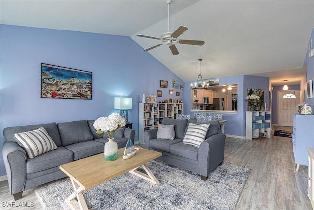 164 Belina Dr E Unit 4, Naples, FL 34104 - living room featuring a ceiling fan, a chandelier, light wood finished floors, and high vaulted ceiling