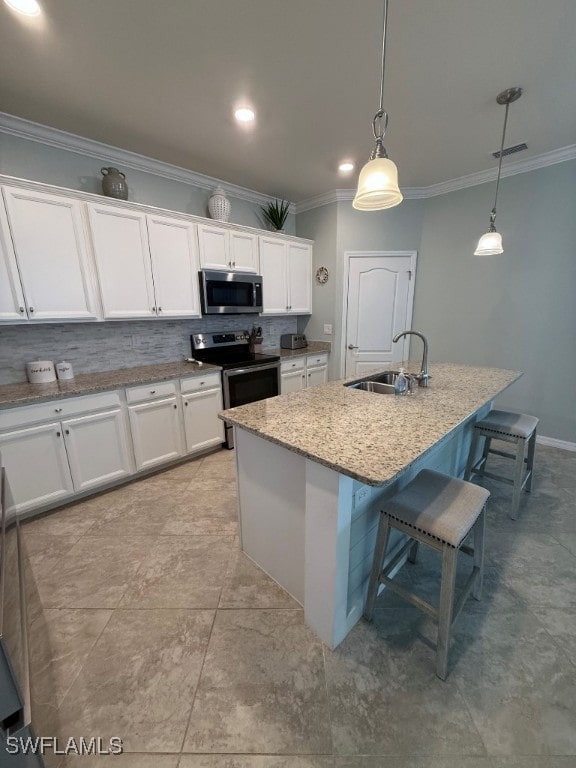 16249 Bonita Landing Cir, Bonita Springs, FL 34135 - kitchen featuring stainless steel appliances, a sink, ornamental molding, white cabinetry, and a kitchen bar