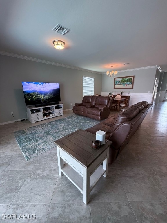 16249 Bonita Landing Cir, Bonita Springs, FL 34135 - living area featuring crown molding, a chandelier, tile patterned flooring, and baseboards